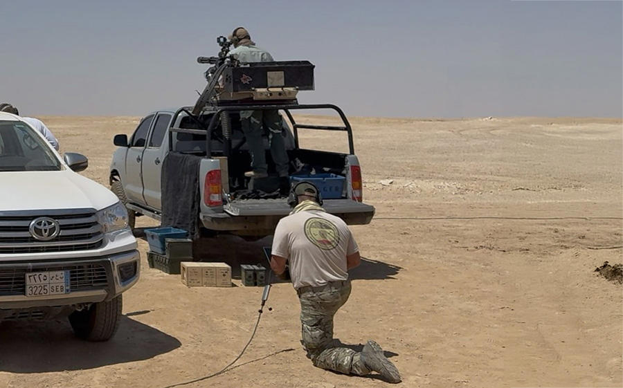 Echodyne&#x27;s Adam Belmonte kneels and calls out radar data.